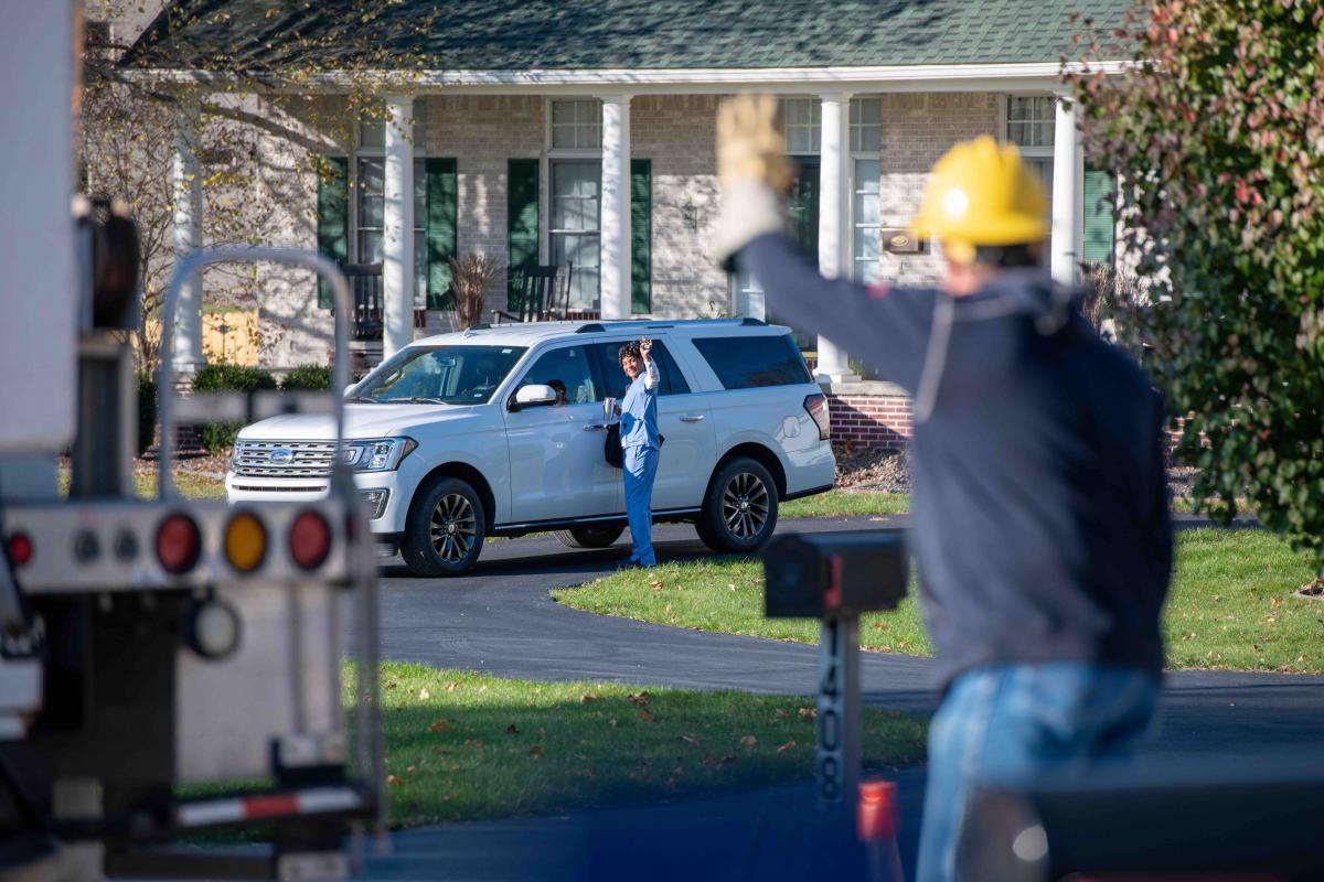 Lineman waving to homeowner