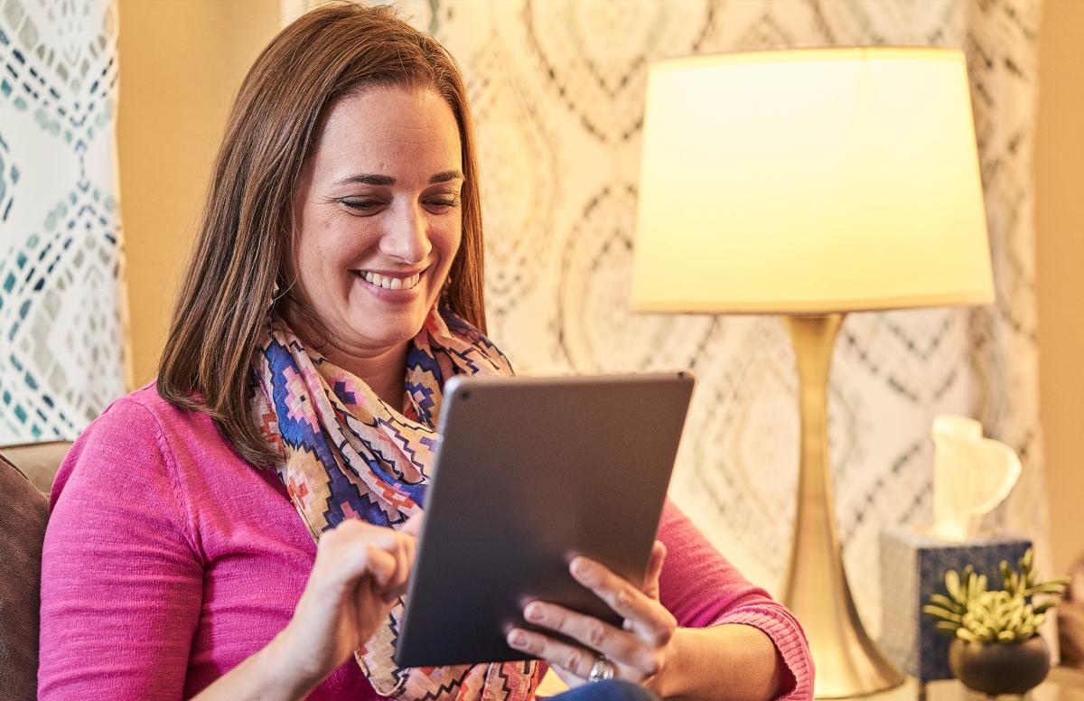 Woman Reading Articles on Tablet