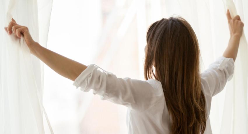 Woman holding curtains