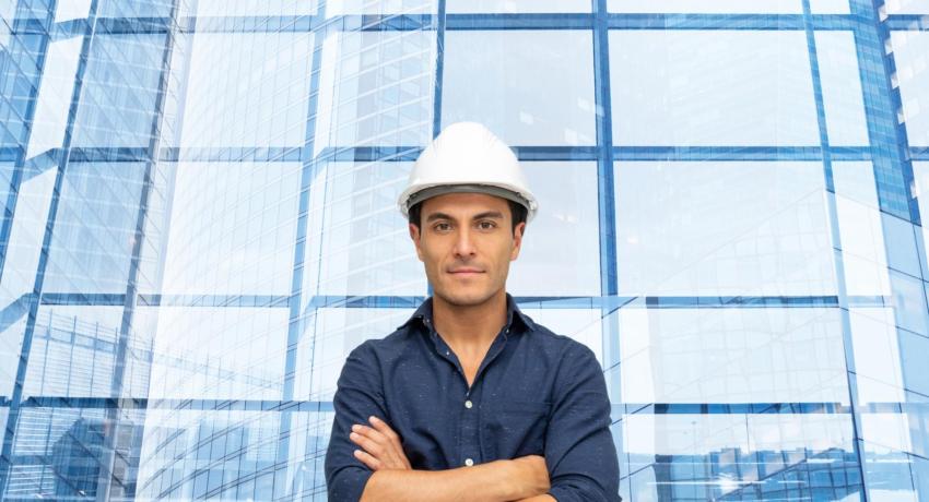 Guy in front of building with arms crosed