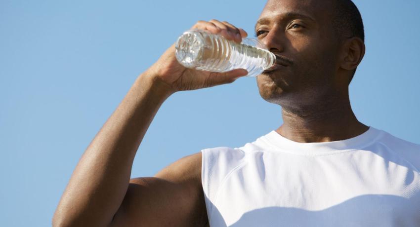 Man drinking water out of a water bottle