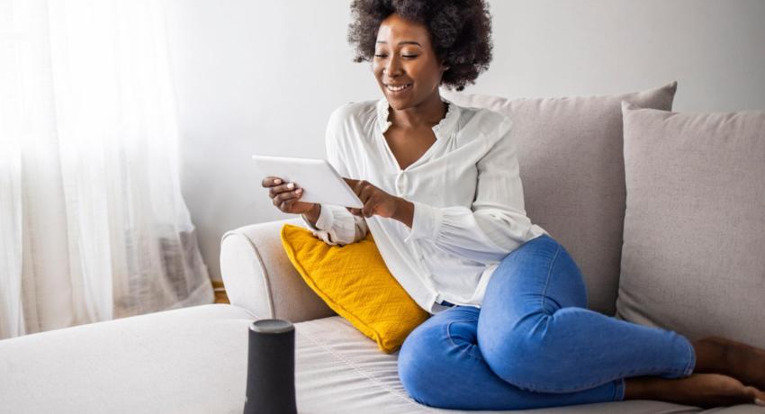 Lady on couch using tablet device