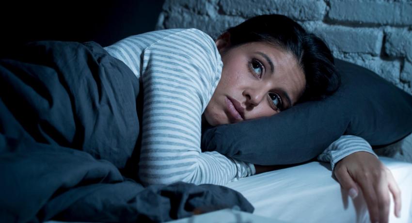 Woman lying in bed.