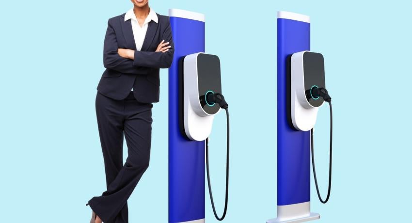 Photo of woman leaning against charging station