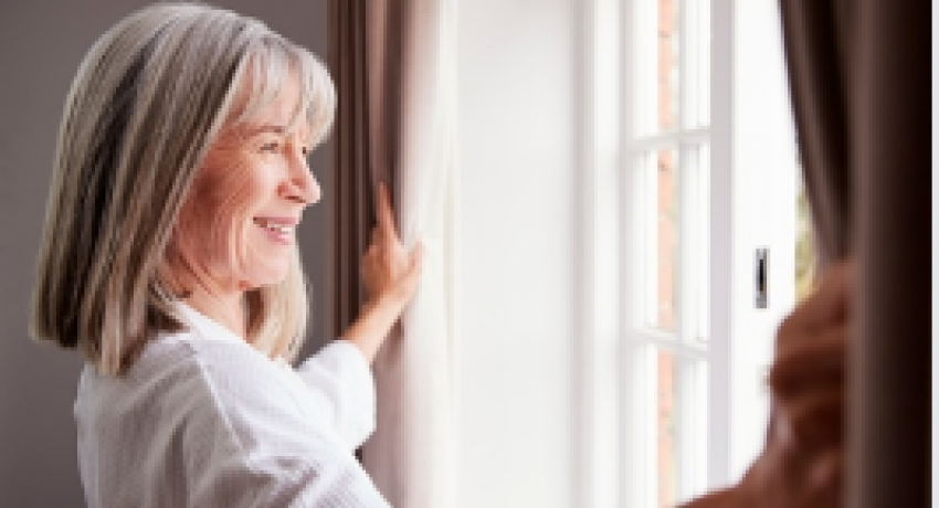 Smiling woman looking out of window