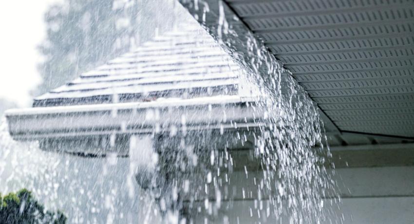 image of rain falling of a roof