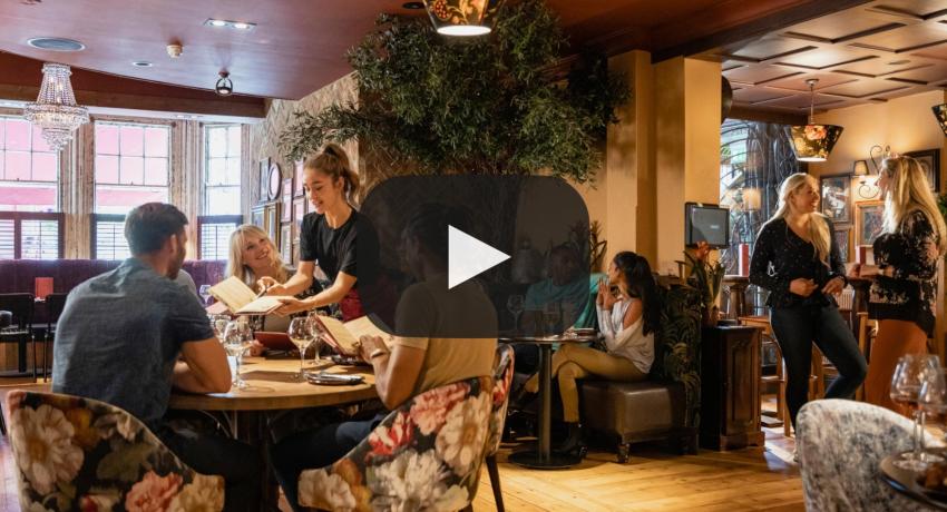 Photo of the inside of a restaurant, showing people talking