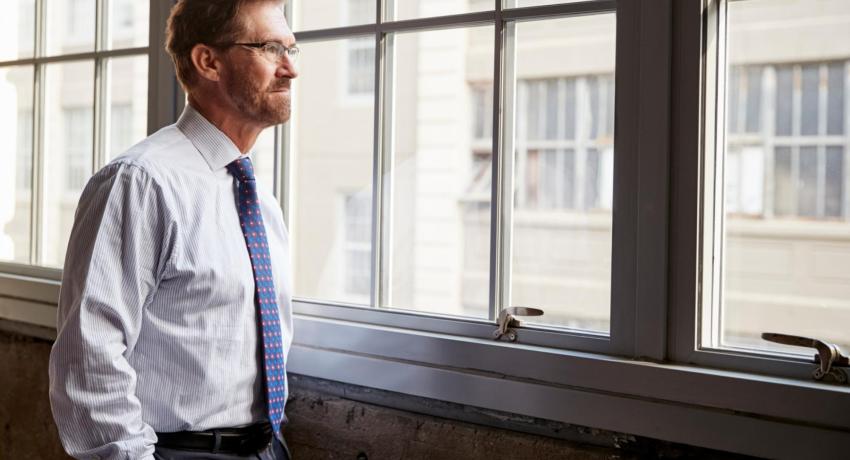 Energy auditor looking out a window