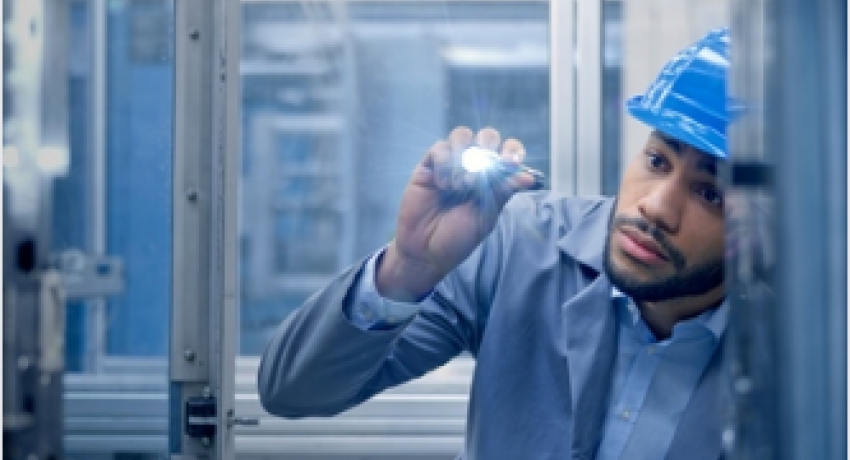 Photo of man with hard hat inspecting facility