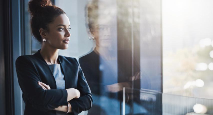image of a woman looking out of an office window