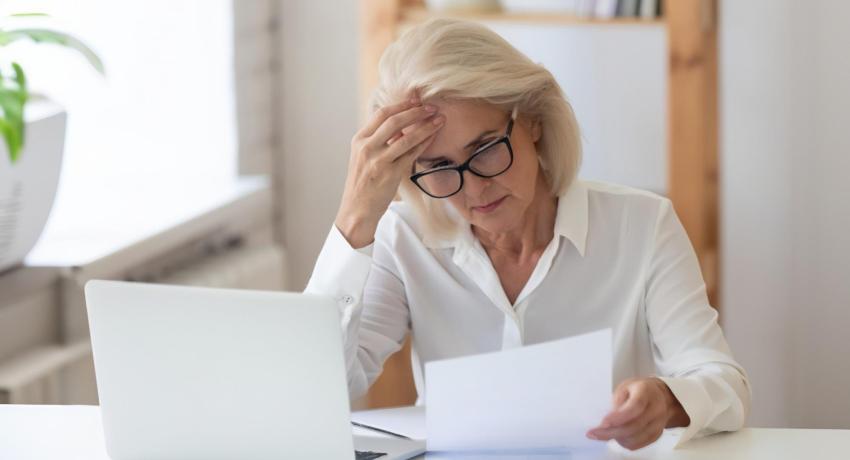 lady upset looking at bill on table