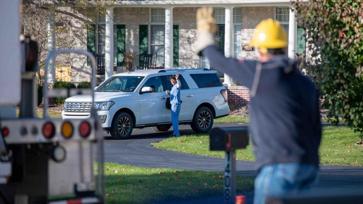 Lineman waving to homeowner