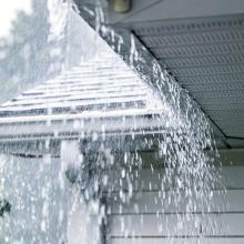 image of rain falling of a roof