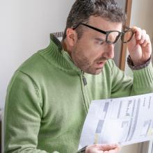 person looking at bill 