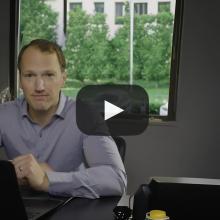 Photo of man sitting in front of a laptop
