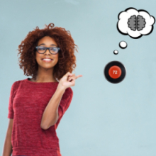 Photo of woman smiling and pointing to smart thermostat